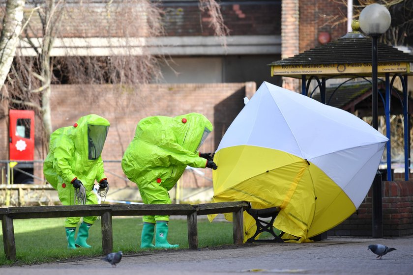 Police officers continue to guard the scene where a forensic tent, covering the bench where Sergei S