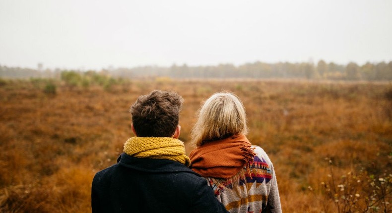 couple hugging in field