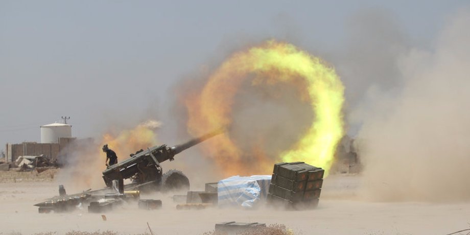 An Iraqi Shi'ite fighter firing artillery during clashes with Islamic State militants near Fallujah, Iraq.