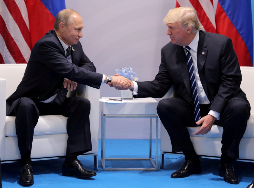 U.S. President Donald Trump and Russia's President Vladimir Putin talk during the family photo sessi