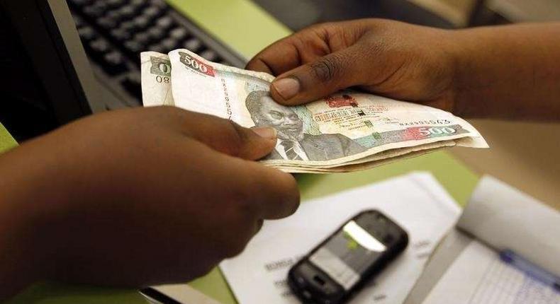 A customer hands over money to a vendor