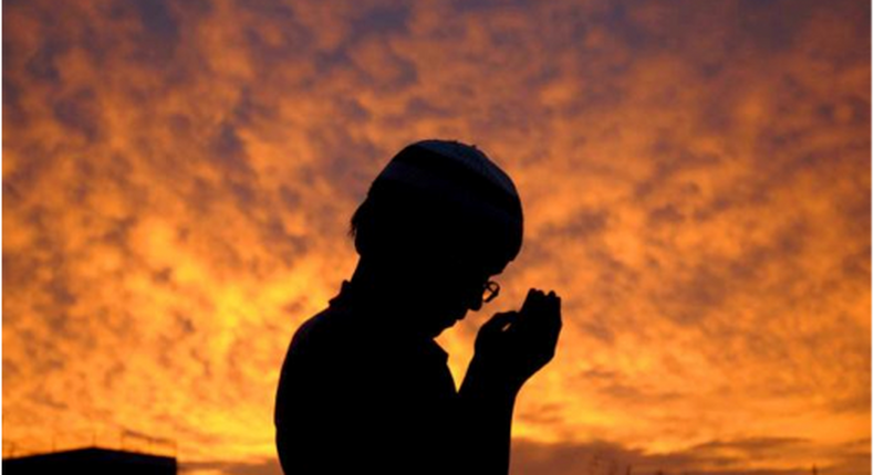 A young Muslim boy praying