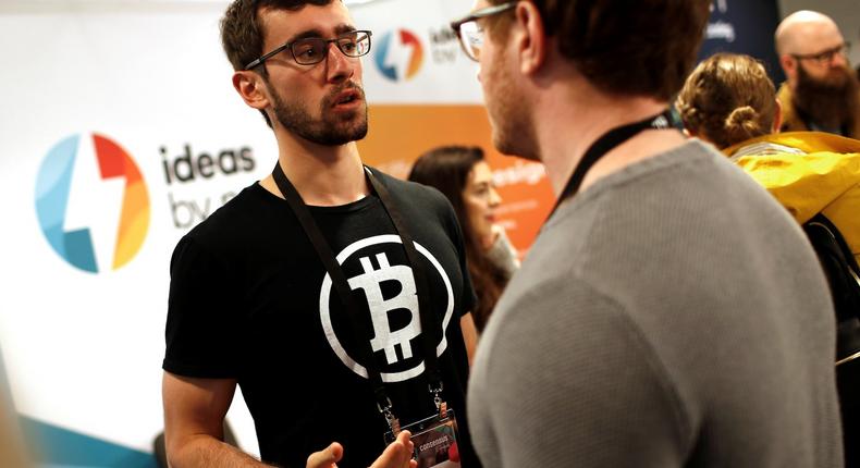 A man wears a Bitcoin logo t-shirt on the floor of the Consensus 2018 blockchain technology conference in New York City, New York, U.S., May 16, 2018.