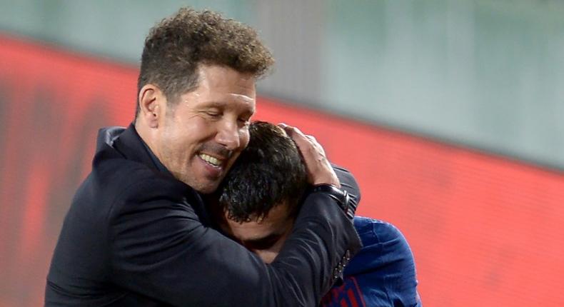 Atletico Madrid coach Diego Simeone hugs Angel Correa at the end of the game