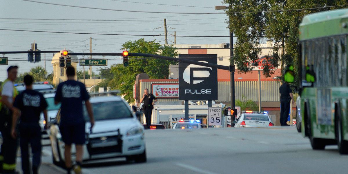 Police officers locked down Orange Avenue on Sunday around the Pulse nightclub, where people were killed by a gunman in a shooting rampage in Orlando, Florida.