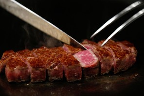 A chef cuts highest award winning female Kobe beef, which is priced 210,000 yen ($2040) per 1kg, at 