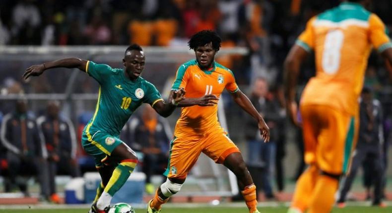 Senegal's forward Sadio Mane (C) vies with Ivory Coast's midfielder Franck Kessie (R) during the friendly football match Ivory Coast vs Senegal, on March 27, 2017, at the Charlety Stadium in Paris