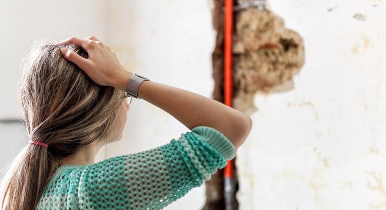 woman looking at water damage