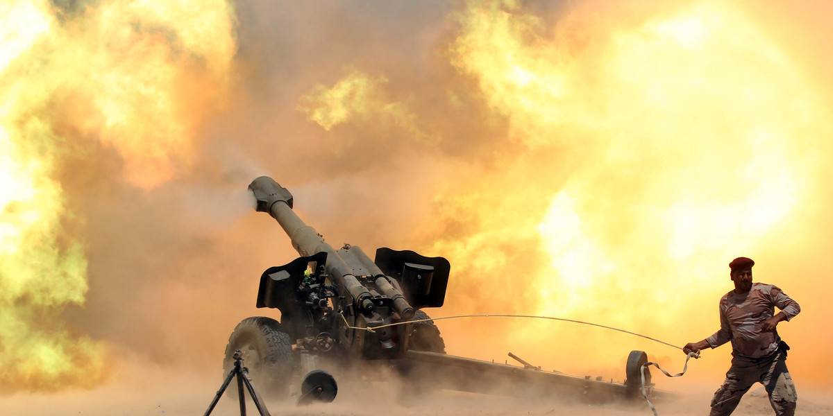 A member of the Iraqi security forces firing artillery during clashes with Islamic State militants near Fallujah, Iraq.