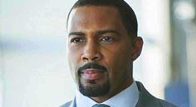 Omari Hardwick in a bright business suit