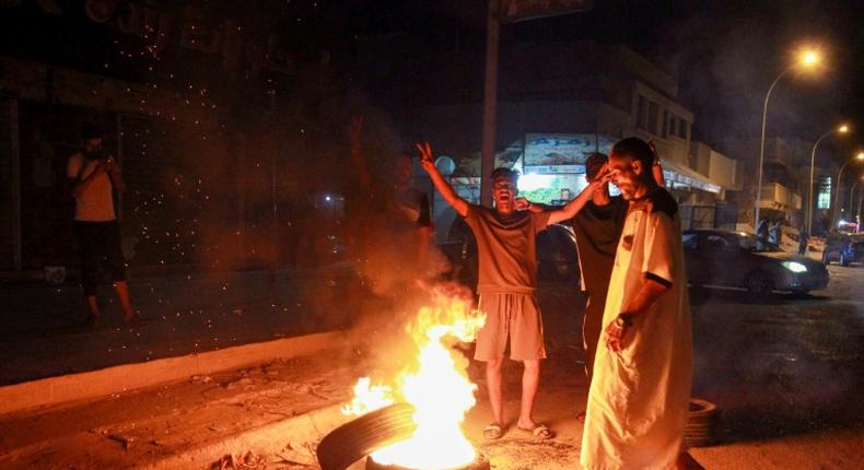 Libyan youth block a road with burning tyres in the eastern city of Benghazi to protest against poor public services and living conditions