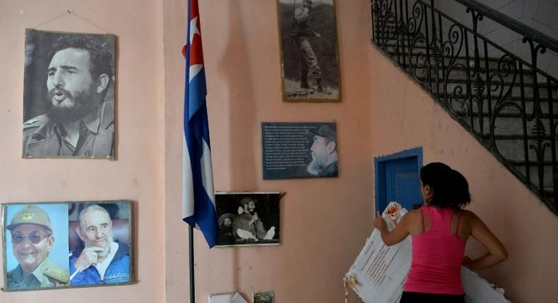 A new center devoted to the study of late Cuban leader Fidel Castro, whose pictures are seen here on the wall of a Havana school, will open by the end of 2019