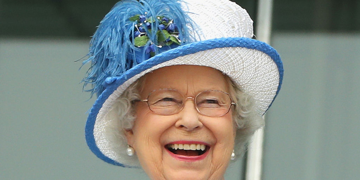 Queen Elizabeth II laughs as she watches the racing at Epsom Racecourse on June 4, 2016 in Epsom, England.