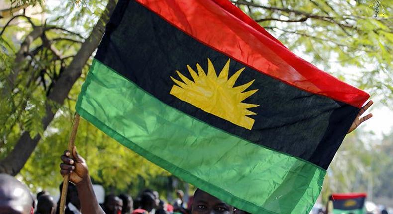 An IPOB supporter holding a Biafran flag