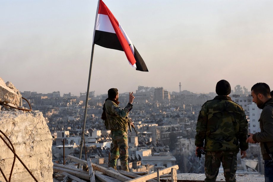 A Syrian soldier overlooks eastern Aleppo after government forces took control of the city's al-Sakhour neighborhood, in this photo provided by SANA on November 28, 2016.