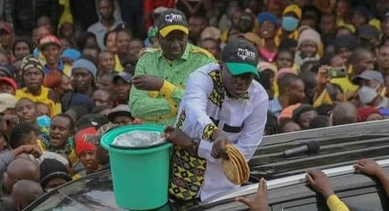 Kenya Kwanza presidential running mate Rigathi Gachagua distributes chapatis to locals in Kiambu County on July 16, 2022