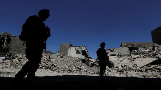 Members of Iraqi federal police patrol in the destroyed Old City of Mosul