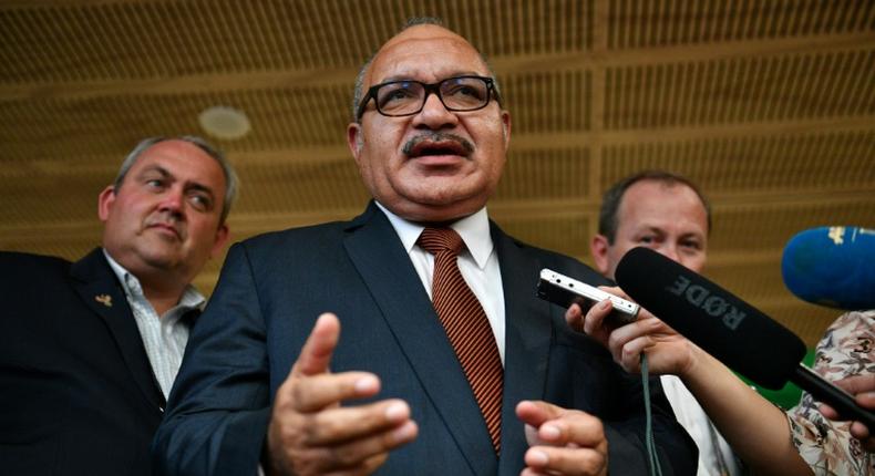 Papua New Guinea's former prime minister Peter O'Neill (C), pictured here in November 2018, has been arrested