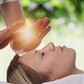 Woman having reiki healing treatment , alternative medicine concept.