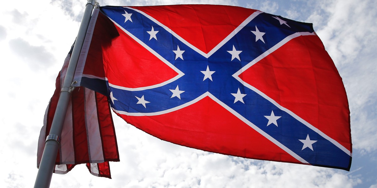 A protester waves a Confederate battle flag in front of the South Carolina statehouse, Thursday, July 9, 2015, in Columbia, S.C.