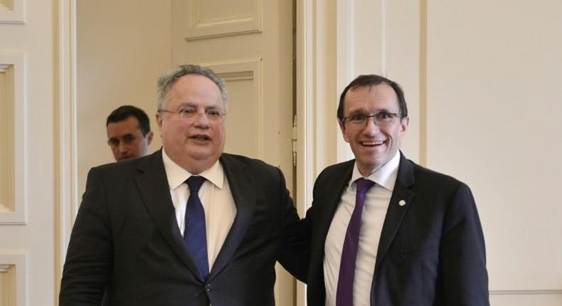 Greek foreign minister Nikos Kotzias (L) poses with UN envoy for Cyprus, Espen Barth Eide prior their meeting in Athens on February 3, 2017