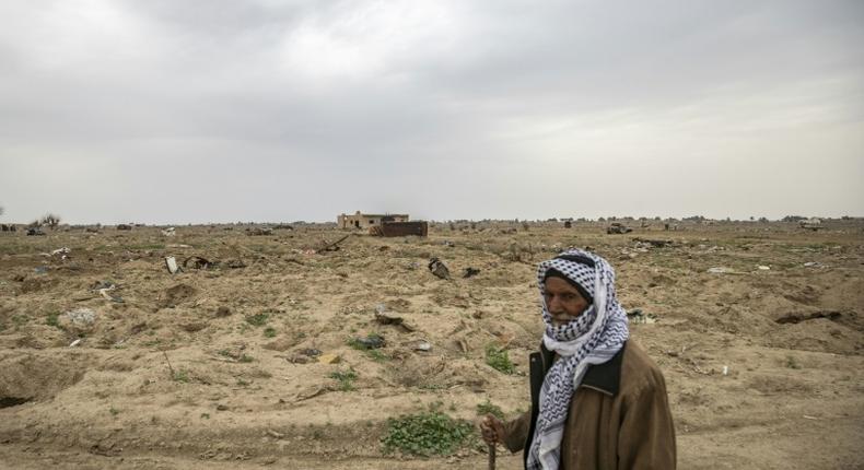 Farmer Hamad al-Ibrahim stands in his damaged fields in the eastern Syrian village of Baghouz