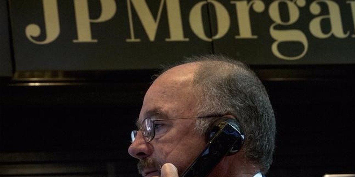 JPMorgan Chase trader Frederick Reimer works in the company's stall on the floor of the New York Stock Exchange