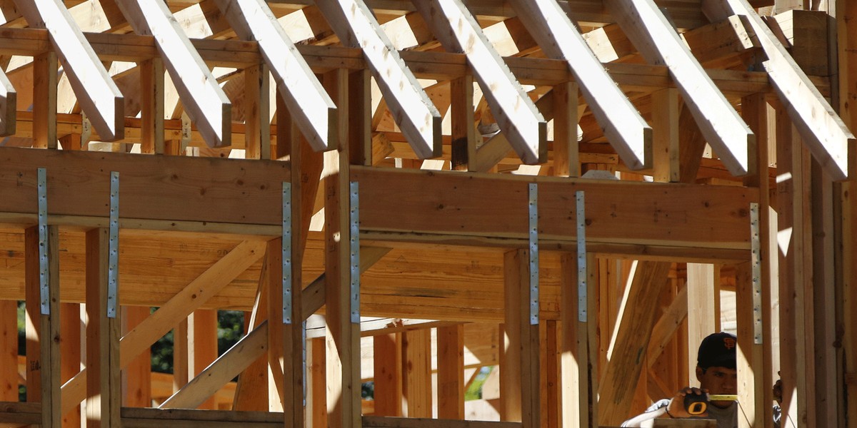 A man works at the job site of a new home in Manhasset, New York.