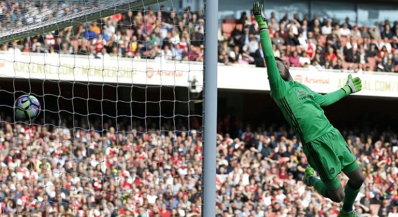 Manchester United's Spanish goalkeeper David de Gea cannot prevent Arsenal's midfielder Granit Xhaka's deflected shot beating him for the opening goal of the English Premier League football match at the Emirates Stadium in London on May 7, 2017