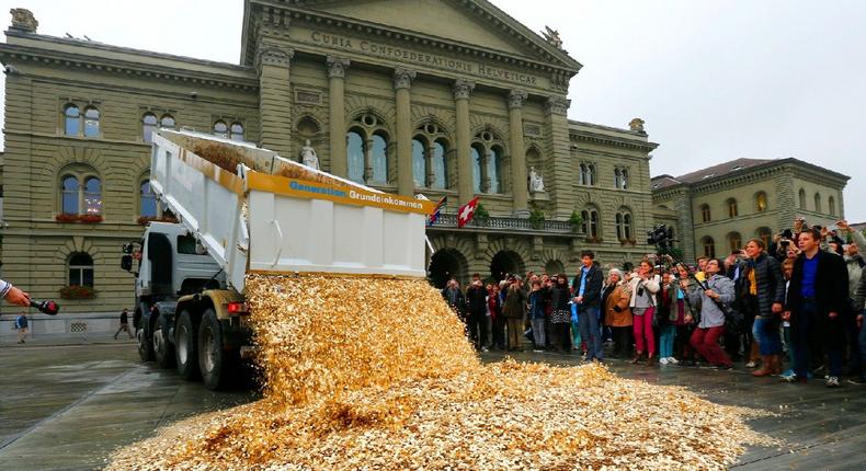 A truck dumps five cent coins in the centre of the Federal Square in Bern, Switzerland.