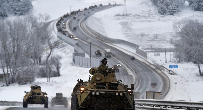 A convoy of Russian armored vehicles moves along a highway in Crimea, Tuesday, Jan. 18, 2022.