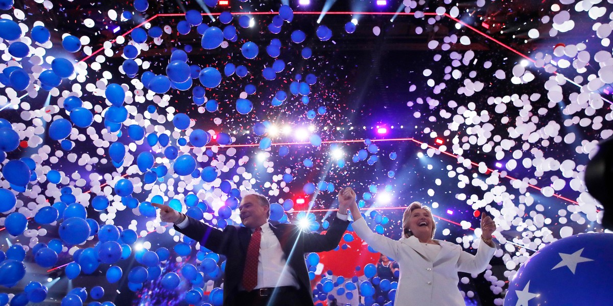 Hillary Clinton and her vice presidential running mate Senator Tim Kaine celebrate among balloons.