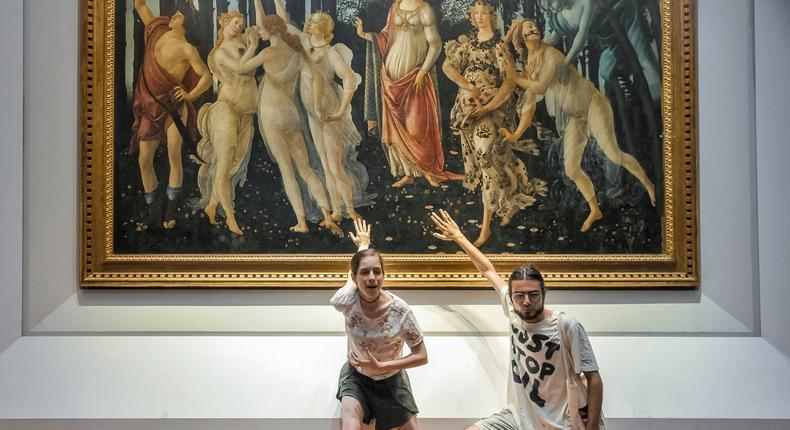 Protestors from the action group Ultima Generazione glue their hands to the glass covering Sandro Botticelli's La Primavera at Uffizi on July 22, 2022 in Florence, Italy.