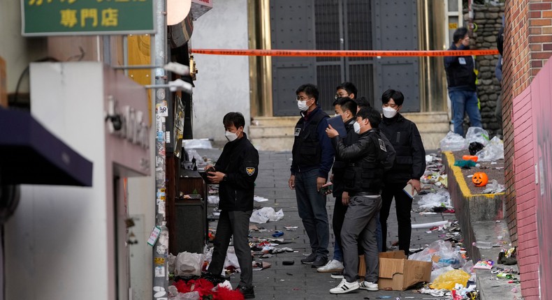 South Korean investigators inspect the scene of a deadly accident following Saturday night's Halloween festivities in Seoul, South Korea, Monday, Oct. 31, 2022.AP Photo/Lee Jin-man