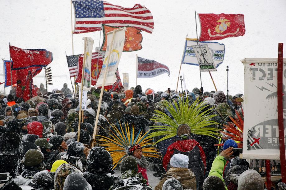 Veterans march with activists near Backwater Bridge just outside the Oceti Sakowin camp during a sno