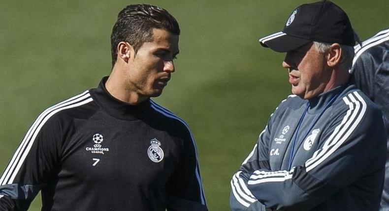 Real Madrid's coach Carlo Ancelotti (R) stands next to Cristiano Ronaldo during their training session at Valdebebas sports ground in Madrid March 9, 2015.