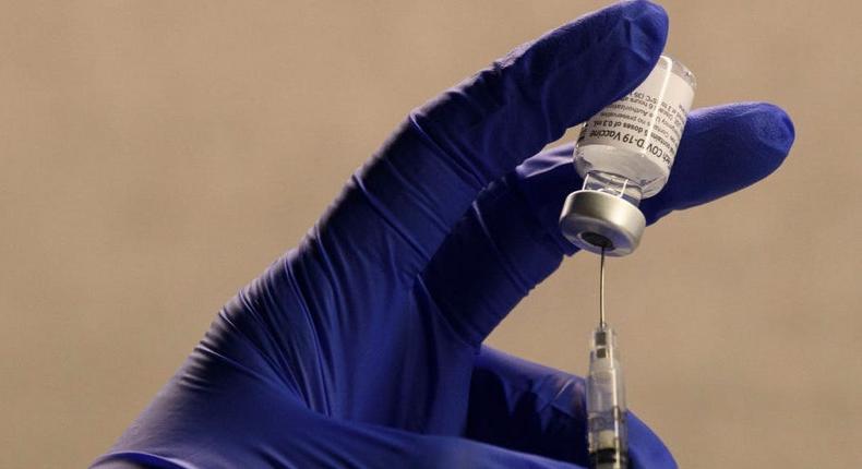 A pharmacist fills a syringe to prepare a dose of the Pfizer-BioNTech Covid-19 vaccine for front-line health care workers at a vaccination site at Torrance Memorial Medical Center on December 19, 2020 in Torrance, California.