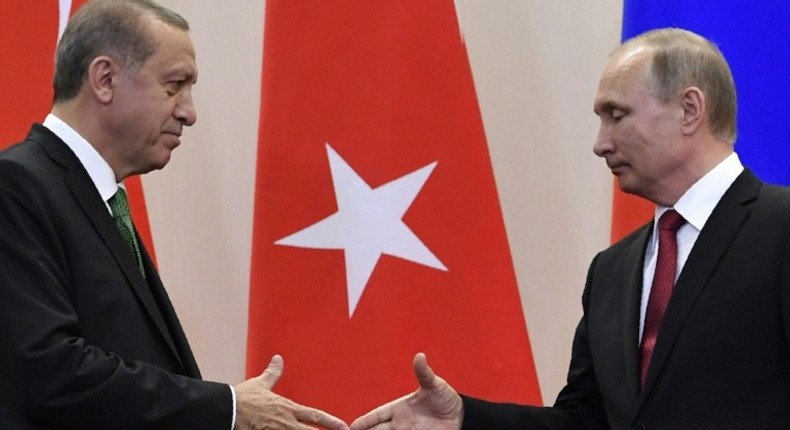 Russian President Vladimir Putin (R) shakes hands with his Turkish counterpart Recep Tayyip Erdogan after a joint press conference following their meeting at the Bocharov Ruchei state residence in Sochi on May 3, 2017