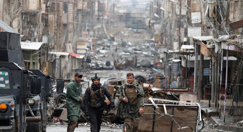 Iraqi special-forces soldiers walk in a street in Mosul, Iraq, March 4, 2017.