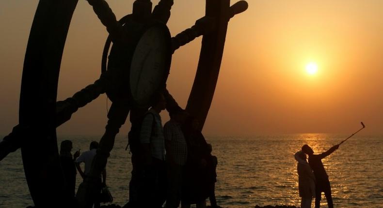 Tourists take a selfie on the seafront on Iran's southern resort island of Kish