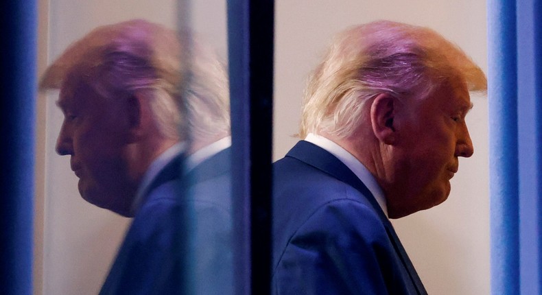 President Donald Trump is reflected as he departs after speaking about the 2020 US presidential election results in the Brady Press Briefing Room at the White House on November 5, 2020.