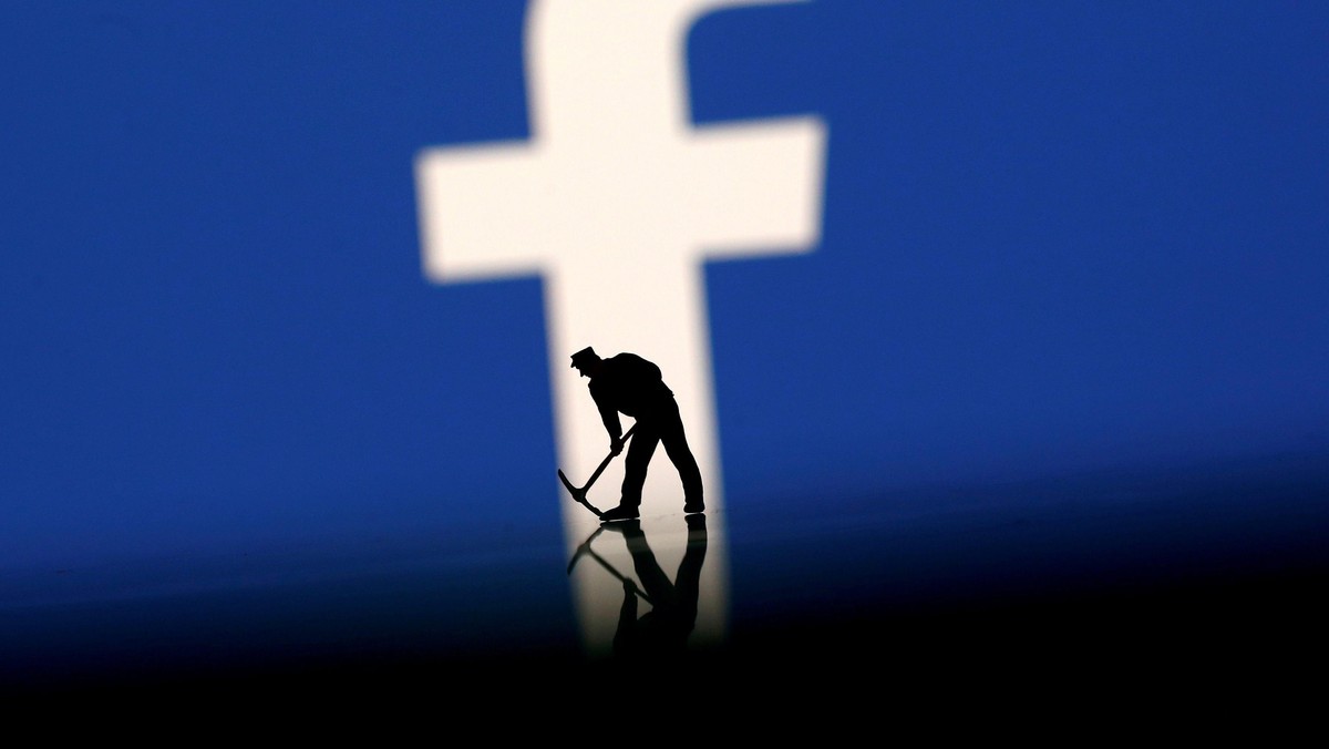 FILE PHOTO: A figurine is seen in front of the Facebook logo in this illustration