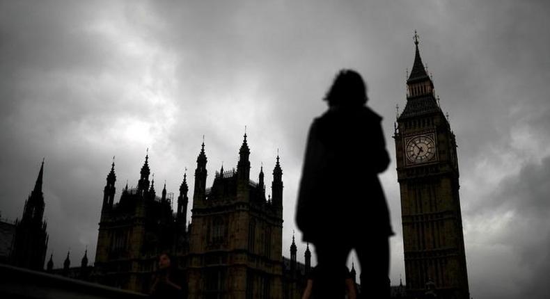 A woman walks past the Houses of Parliament and the Big Ben clock tower, on the day of the EU referendum, in central London, Britain June 23, 2016.