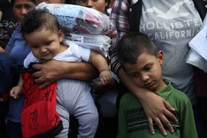 Children of undocumented immigrant families react as they are released from detention at a bus depot