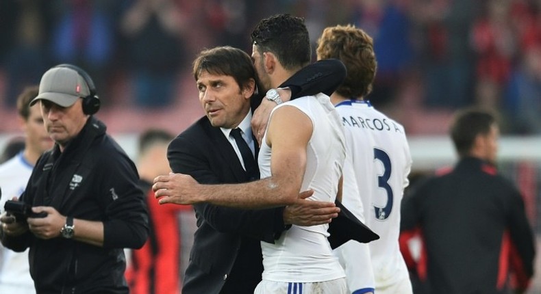 Chelsea's head coach Antonio Conte (L) embraces Chelsea's striker Diego Costa (R) at the end of the English Premier League football match between Bournemouth and Chelsea at the Vitality Stadium in Bournemouth, southern England on April 8, 2017