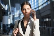 Concentrated woman talking on phone in office