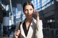 Concentrated woman talking on phone in office