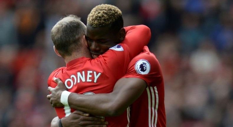 Manchester United's midfielder Paul Pogba (R) embraces striker Wayne Rooney after scoring against Cyrstal Palace on May 21, 2017