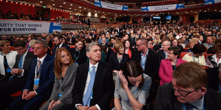 Britain's Chancellor of Exchequer Philip Hammond watches Prime Minister Theresa May speak at the annual Conservative Party Conference in Birmingham, Britain, October 2, 2016.