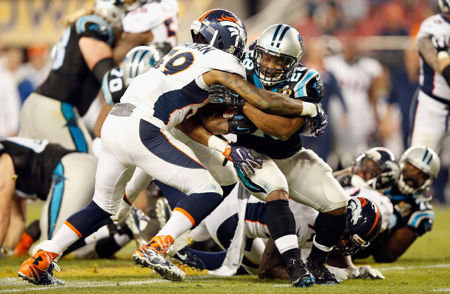 Jonathan Stewart, No. 28, of the Carolina Panthers is tackled by Danny Trevathan, No. 59, of the Denver Broncos during Super Bowl 50 at Levi's Stadium on February 7, 2016.